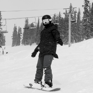 black and white photo of a snowboarder on vacation in colorado